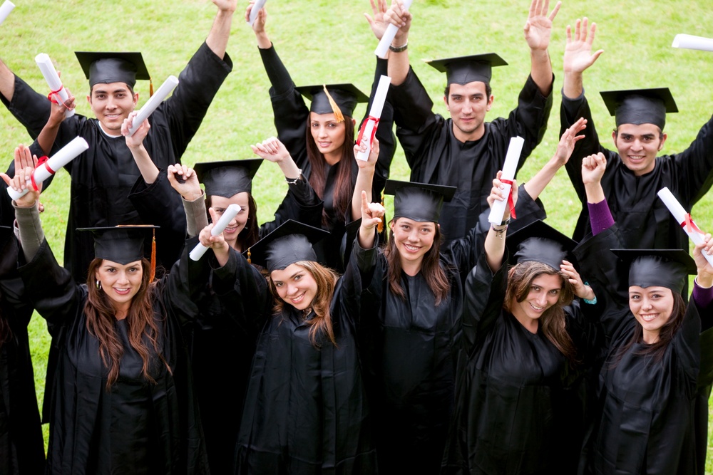 group of graduation students looking happy outdoors.jpeg